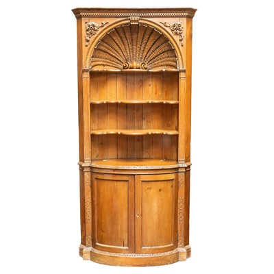 Lot 180 - A carved pine corner cupboard