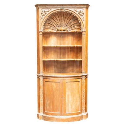 Lot 179 - A carved pine corner cupboard