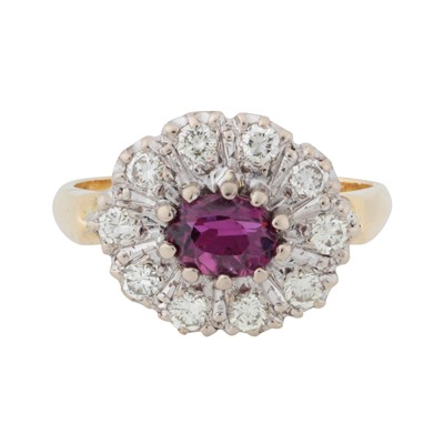 Lot 154 - A ruby and diamond halo ring, circa 1975