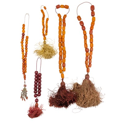 Lot 452 - A group of amber / celluloid necklaces