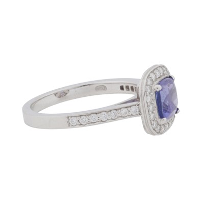 Lot 65 - A diamond and tanzanite halo ring, circa 2011