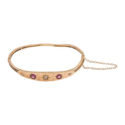 Lot 53 - A garnet and diamond bangle, circa 1977