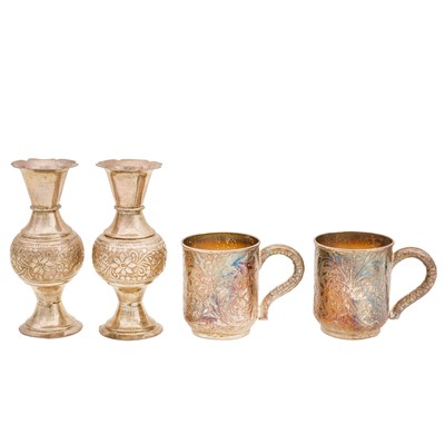 Lot 748 - A pair of mid 20th century Omani unmarked silver mugs