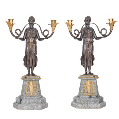 Lot 160 - A pair of Empire style patinated and gilt bronze figural two light candelabra