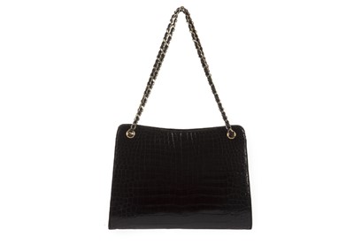 Lot 455 - Cartier black baby crocodile and gold handbag,...