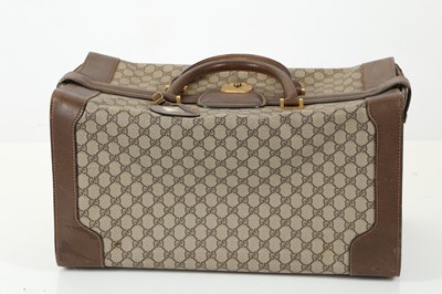 Lot 314 - Three monogram Gucci travel bags, 1990s, brown...