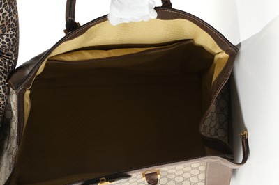 Lot 314 - Three monogram Gucci travel bags, 1990s, brown...