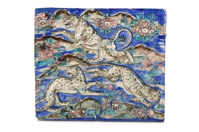 Lot 148 - A QAJAR MOULDED POTTERY TILE WITH LEOPARDS...