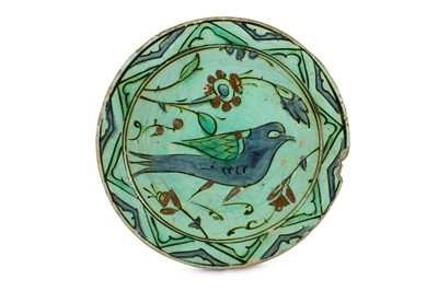 Lot 82 - A FIGURAL IZNIK POTTERY DISH Ottoman Turkey,...