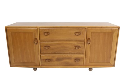 Lot 654 - A 1960s Ercol Windsor blonde elm sideboard to...