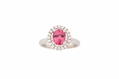 Lot 765 - A purple spinel and diamond cluster ring, set...