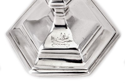 Lot 3 - A matched pair of George I / George II Britannia standard and sterling silver candlesticks, London 1715 by Richard Greene (reg. 15th April 1703) and London 1731 by James Gould (reg. 19th Nov 1722)