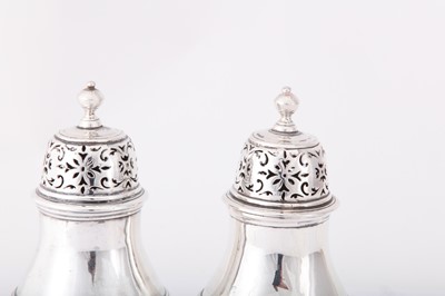 Lot 2 - A pair of George I Britannia standard silver pepper casters, London 1714 by Samuel Welder (first reg. 4th Aug 1714)