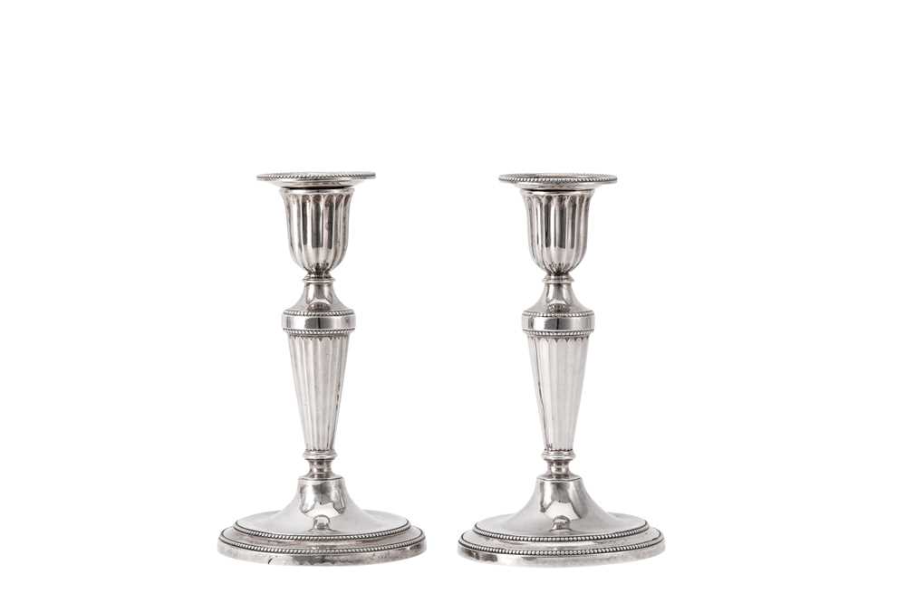 Lot 33 - A rare pair of George III sterling silver diminutive or library candlesticks, London 1782 by John Scofield (reg. 13th Jan 1778)