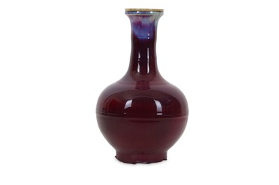 Lot 523 - A CHINESE FLAMBE BOTTLE VASE. The ovoid body...